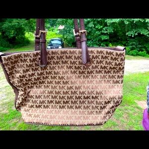 Lightly used Michael Kors purse with MK print.